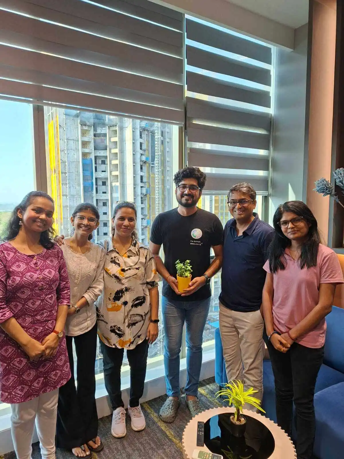 Team portrait with potted plant