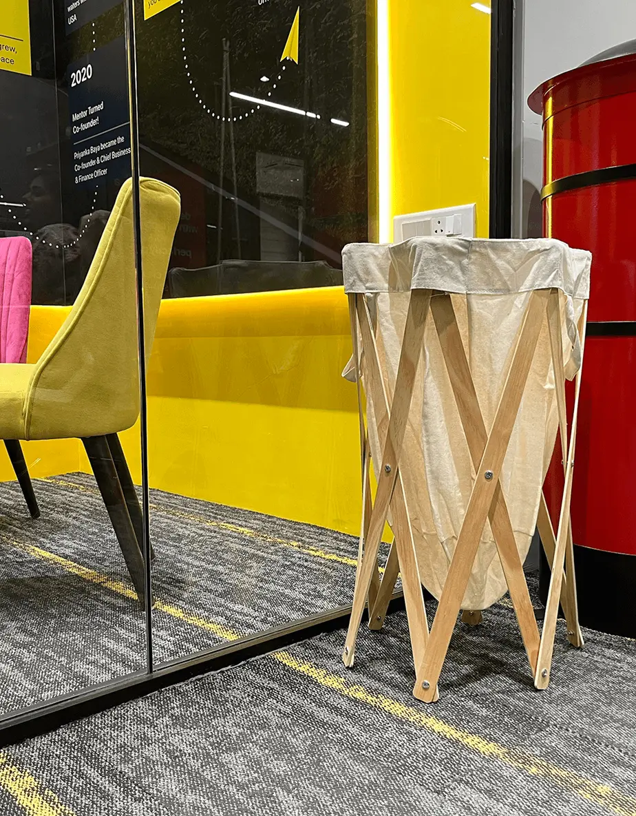 Donated clothes basket by a mirror and yellow wall